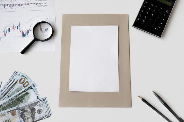 Vista superior de calculadora, caneta e materiais financeiros sobre uma mesa, com uma folha em branco.